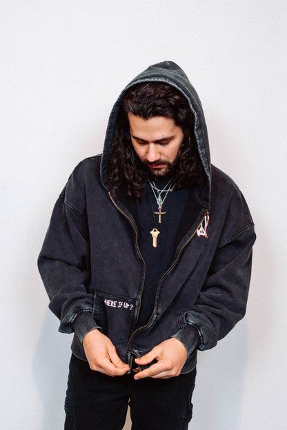 Man wearing a black hoodie against a white background