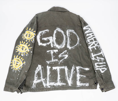 Gray/green jacket with 'God is Alive' and eye designs on a white background