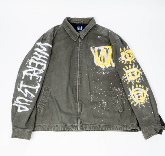 Gray/green canvas jacket with graffiti-style designs on a white background