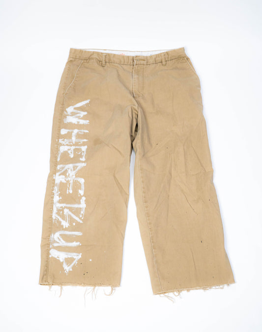 Beige pants with white text on a white background