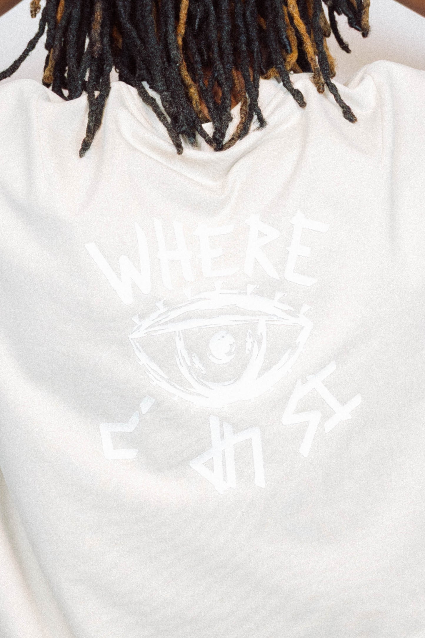 Man wearing limited edition "REVIVAL" Cut -off tee in front of a white background