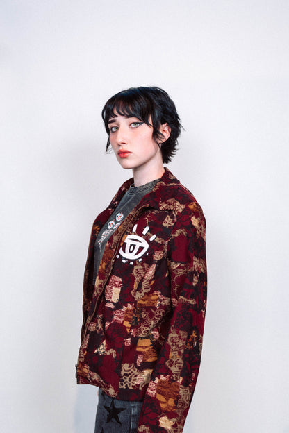 girl wearing a 1 of 1 hand painted pattern jacket with white paint in front of a white background