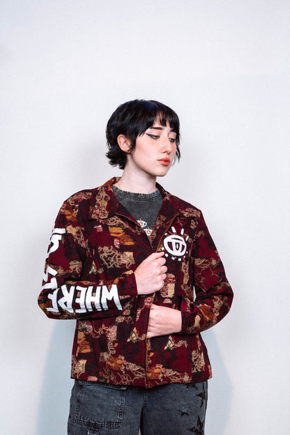 girl wearing a 1 of 1 hand painted pattern jacket with white paint in front of a white background