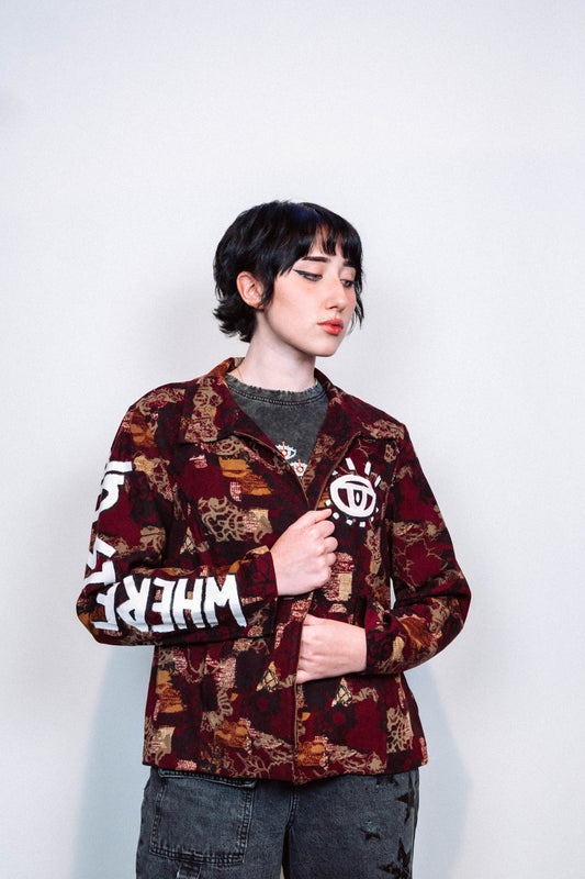 girl wearing a 1 of 1 hand painted pattern jacket with white paint in front of a white background