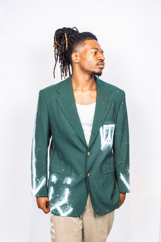 Man wearing a 1 of 1 Handpainted and spray painted vintage green suit blaser in front of a white background