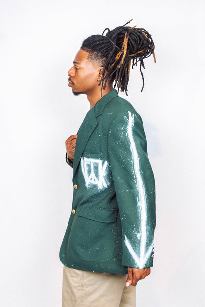 Man wearing a 1 of 1 Hand Painted and spray painted vintage green suit blazer in front of a white background.